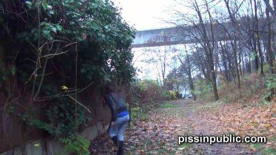 Blonde teen dares to pee on the frequented walkway and gets a public surprise - sexu.com